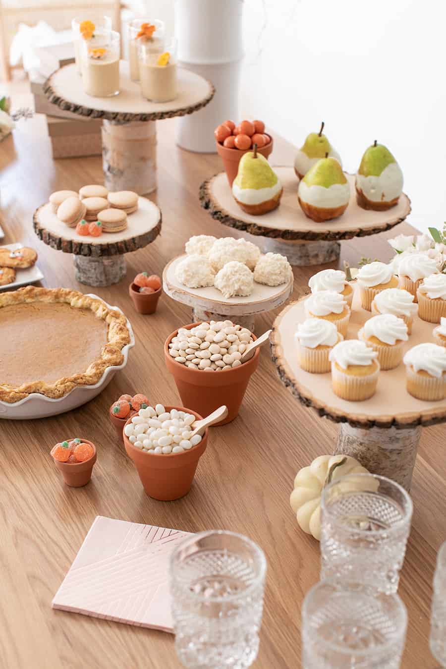 Autumn dessert table with macarons, cupcakes, and dipped fruit